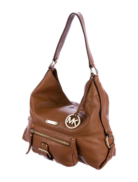 are michael kors handbags real leather|is Michael Kors leather real.